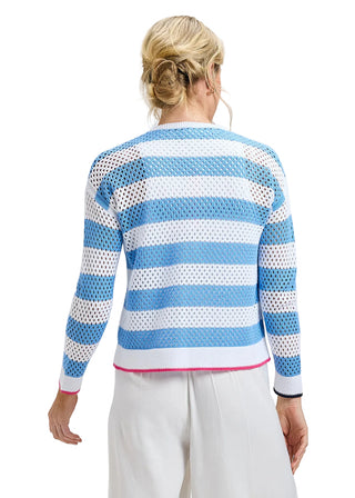 Woman wearing a blue and white striped sweater with a textured pattern on a gray background