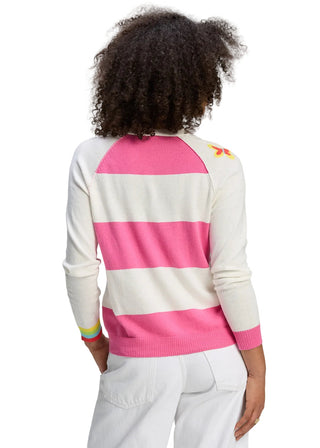 Person wearing a white and pink striped sweater on a gray background