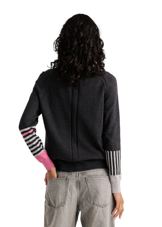 A model shown from the back wearing a dark gray knit cardigan with distinctive striped sleeve cuffs and a bright pink cuff accent, paired with light gray jeans against a plain light background.
