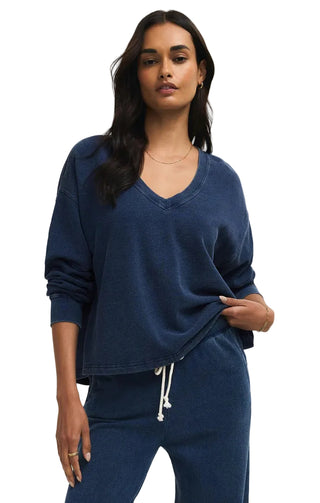 Woman wearing a blue outfit on a beige background