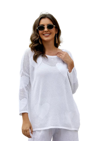 Woman wearing a white outfit with sunglasses in a tropical setting