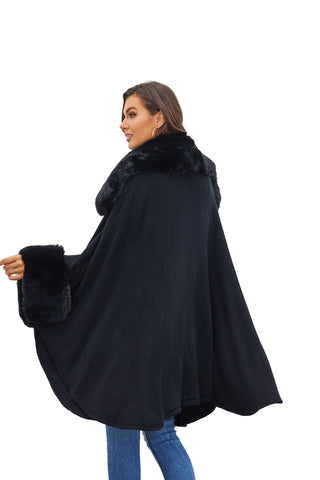 Woman wearing a black cape with fur trim against a light gray background
