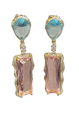 Earrings with blue and pink gemstones on a metal stand
