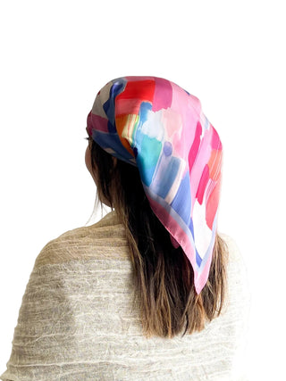 Person wearing a colorful headscarf on a white background