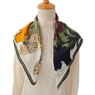 Mannequin wearing a floral patterned scarf with a plain background