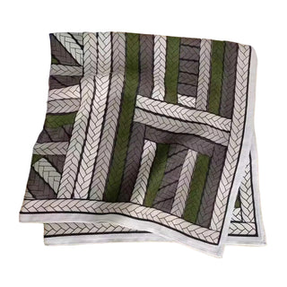 Patterned fabric with geometric design on a beige surface, featuring LOEWE branding.