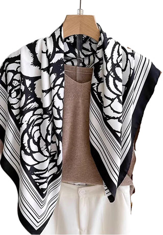 Black and white patterned scarf draped over a mannequin with a neutral background