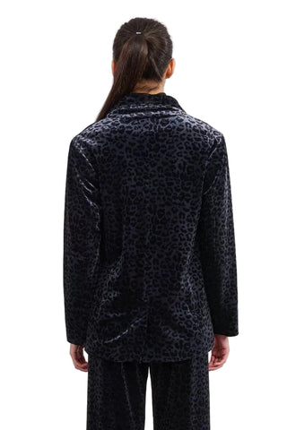 Person wearing a black leopard print coat on a white background