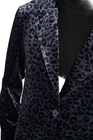 Black velvet blazer with leopard print lapels on a plain background