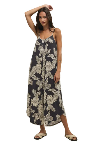 Woman wearing a navy floral dress on a white background